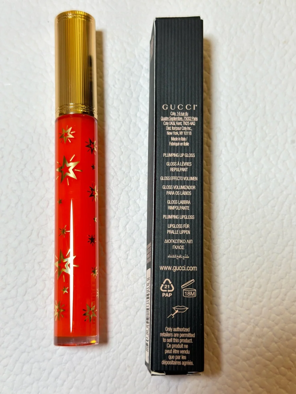 Gucci Orange-Red Lip Gloss with Gold Star Accents